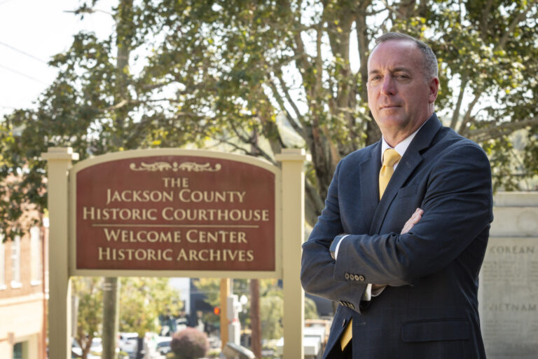 Scott R. Tolbert standing in front of the Jackson County Historic Courthouse